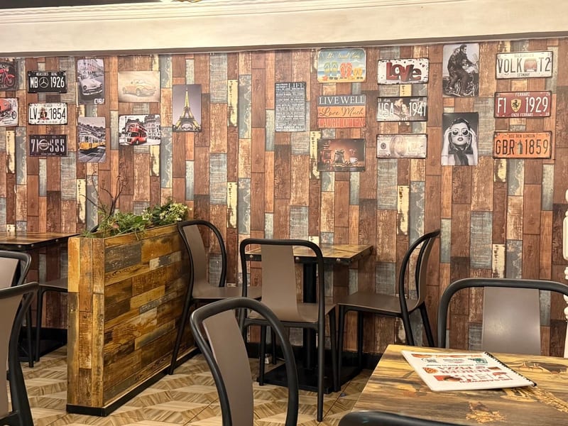 A café wall of old license plates and signs
