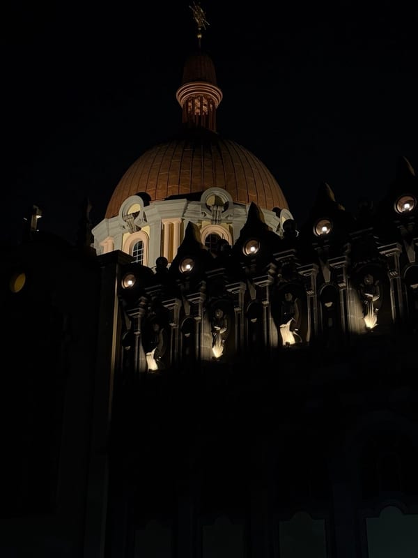 A church dome lit up at night