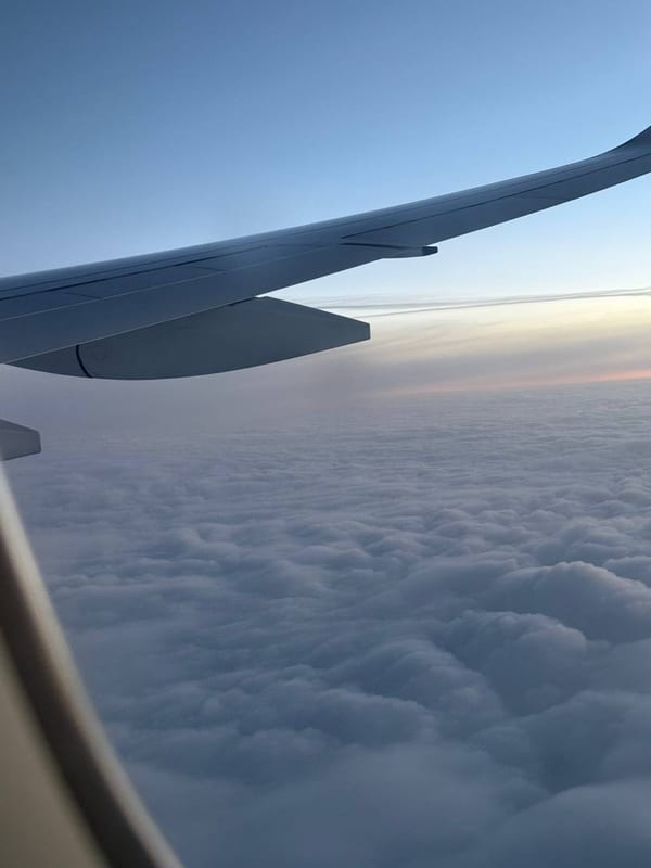 A wing over a sea of clouds