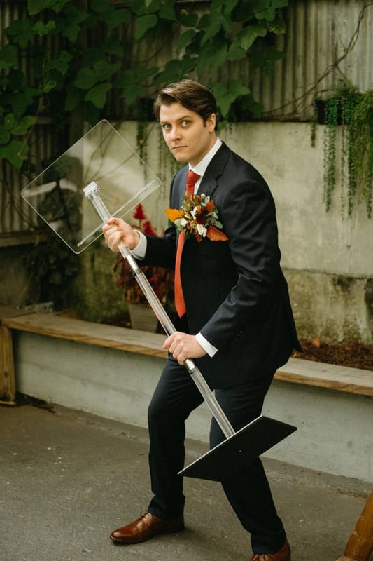 A man in a suit dancing with a lamp