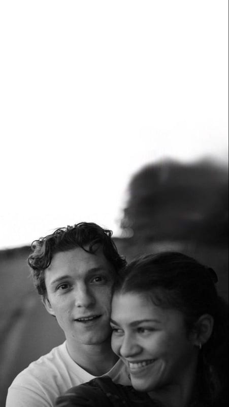 Tom Holland and Zendaya smiling, in black and white