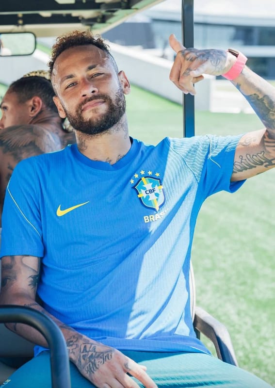 Neymar smiling in a blue Brazil shirt