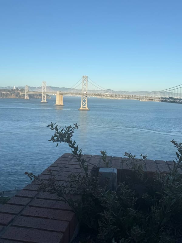 The Bay Bridge across still water