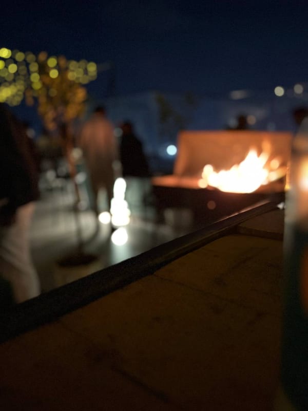A fire pit on a rooftop at night
