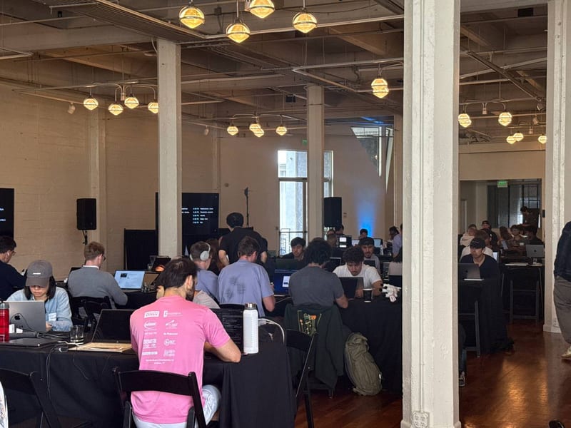 A hall full of people at a hackathon