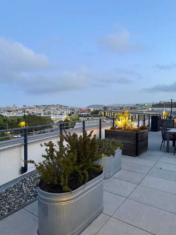 A rooftop terrace, the city beyond