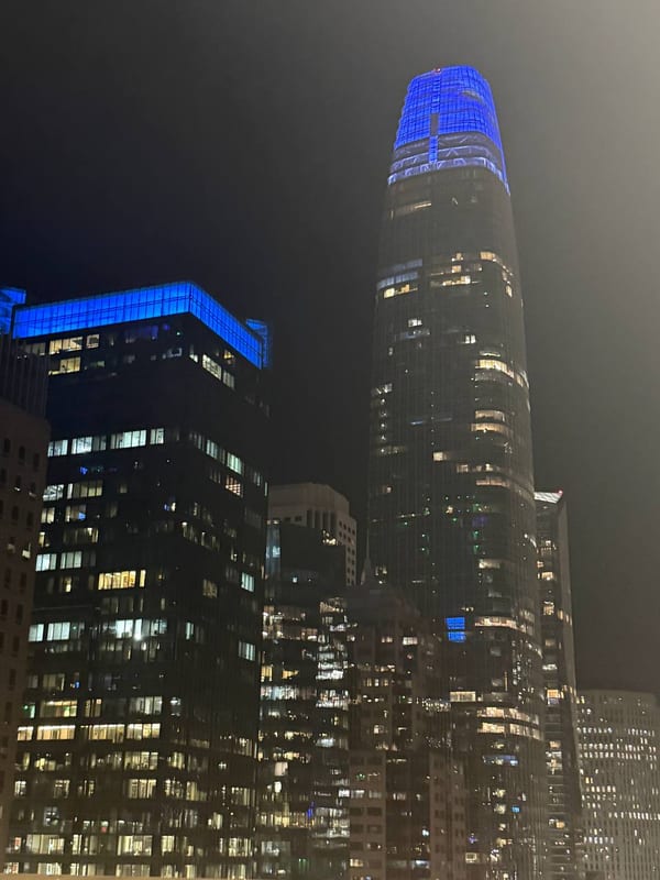 Salesforce Tower lit blue at night