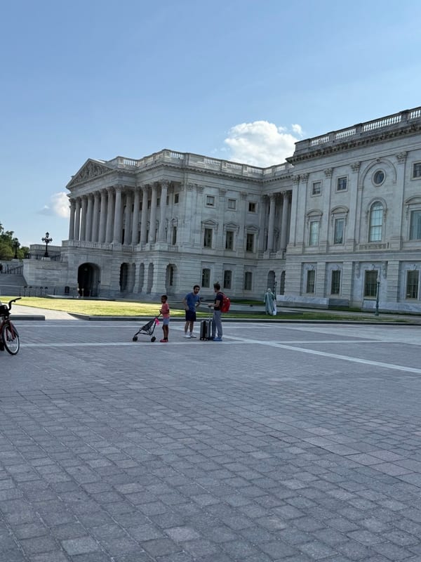 A wing of the Capitol across an empty plaza